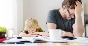 Frustrated father and child sitting at a cluttered table—highlighting how ADHD can affect both parenting and learning. Strategic Hypnotherapy from Mindshift Mentors offers support for emotional regulation and family balance.
