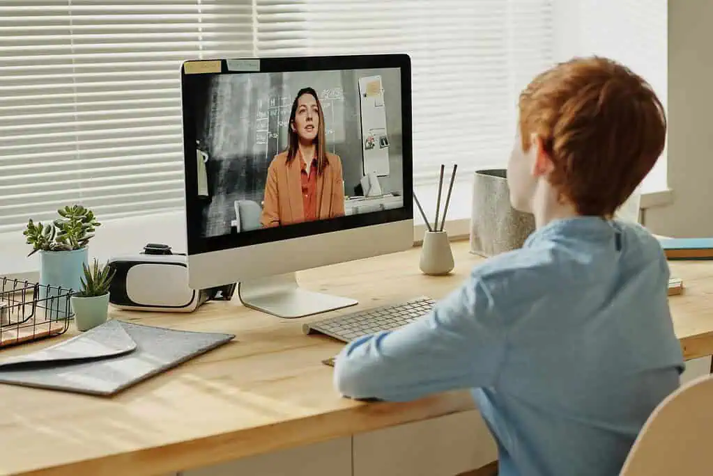 Child attending an online session with a therapist on a computer, representing Strategic Hypnotherapy support for ADHD