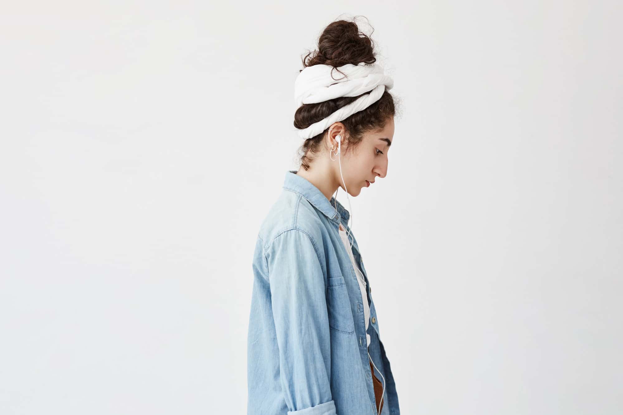 Woman listening to a session with one earphone in