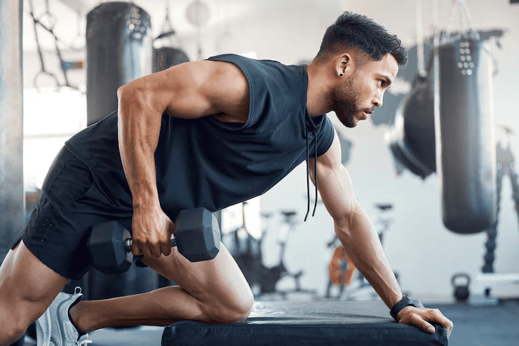 Bad day can be made better by going gym shot sporty young man exercising with dumbbell gym