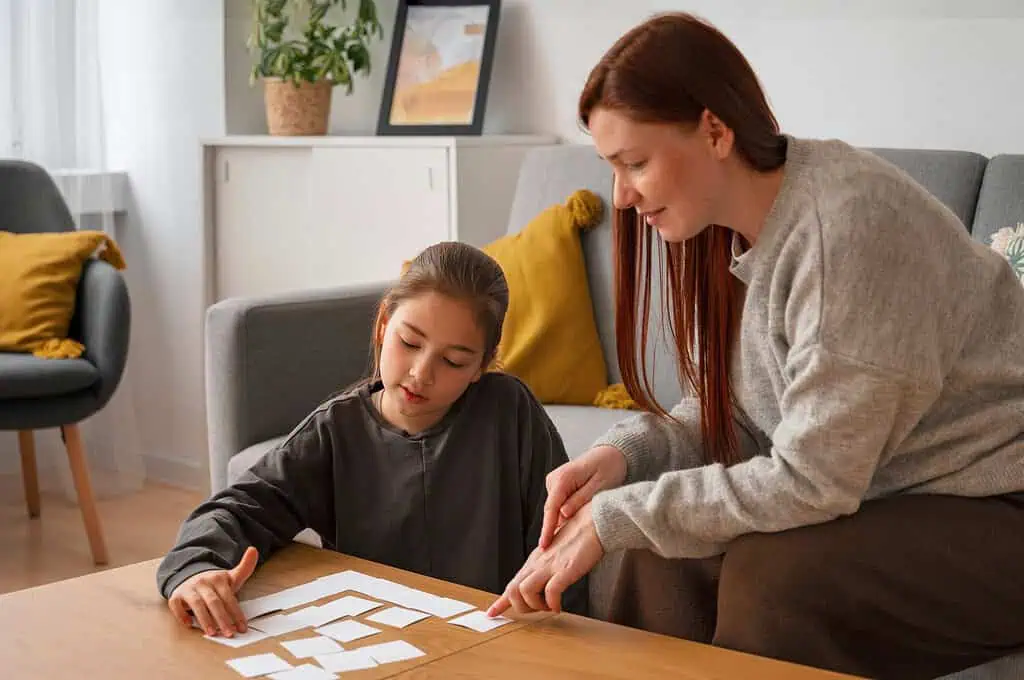 A young girl working with a therapist on a puzzle activity, showing cognitive and motor skill support for children with Developmental Coordination Disorder (DCD).