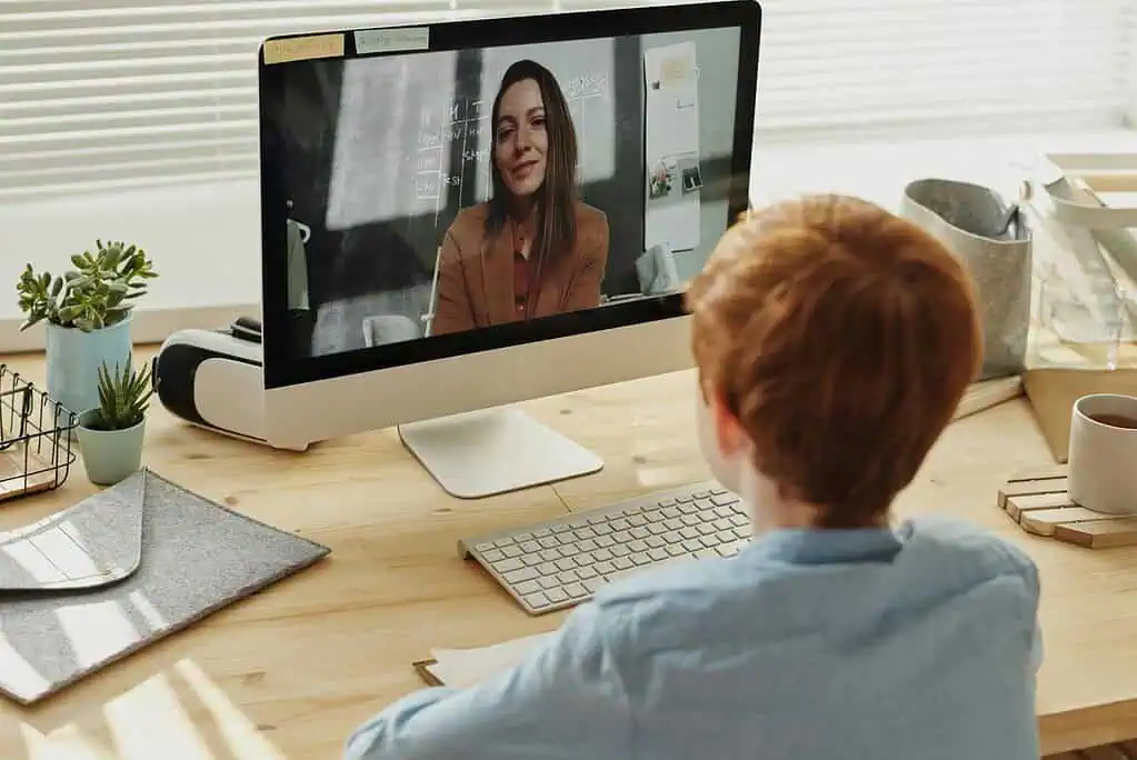 Child attending an online session with a therapist on a computer, representing how Strategic Hypnotherapy can support ADHD friendly routines.
