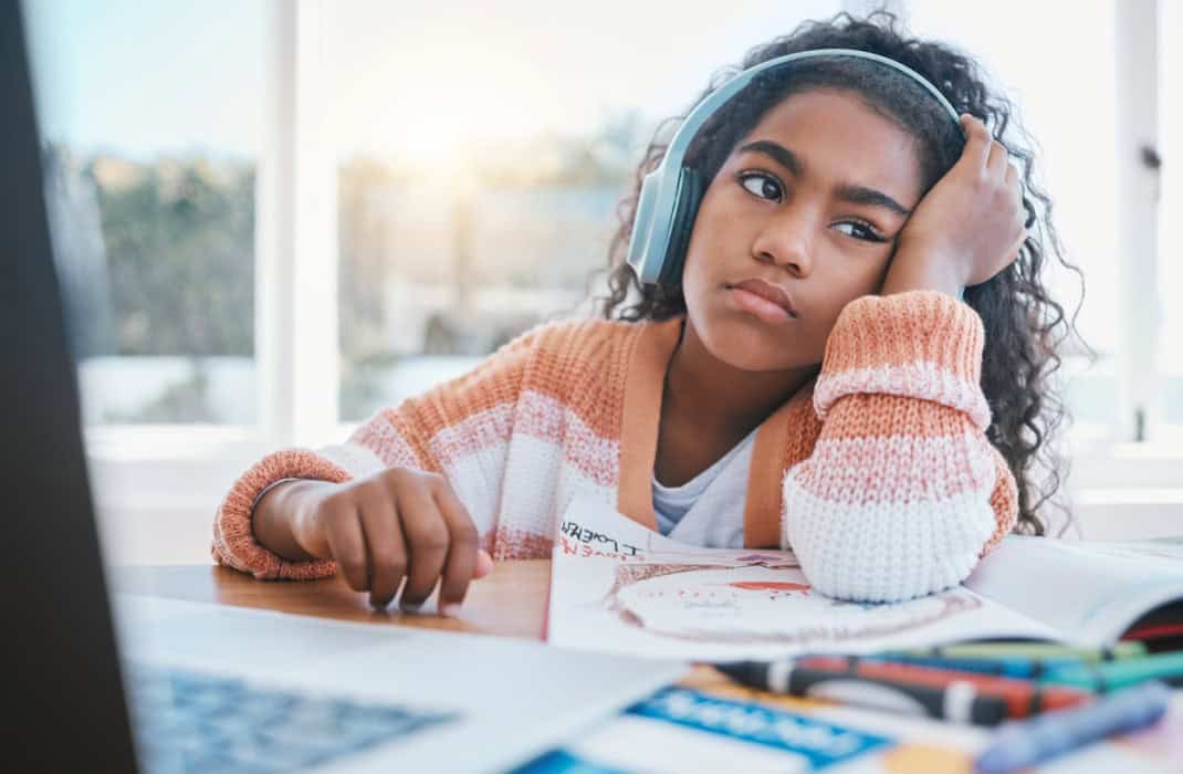 Young girl with headphones studying